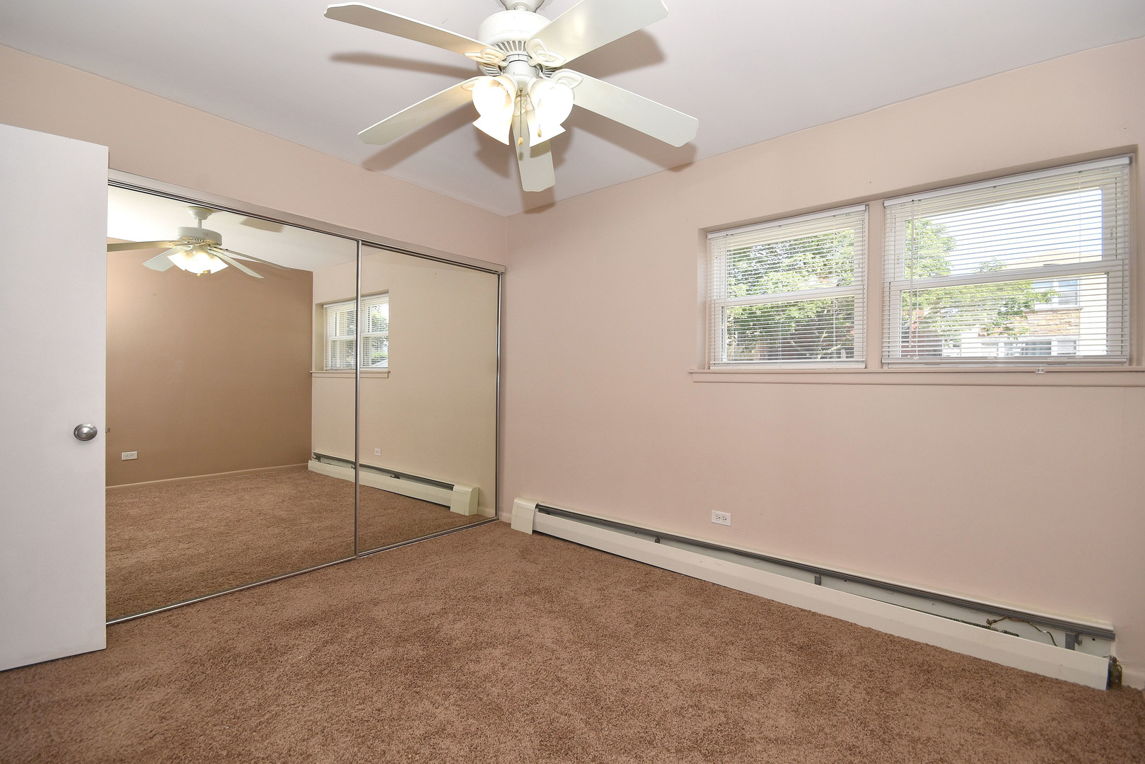 6152 West Rosedale Avenue, Unit 1 Chicago, IL 60646 - Photo 17 of 18 an empty room with fan and windows