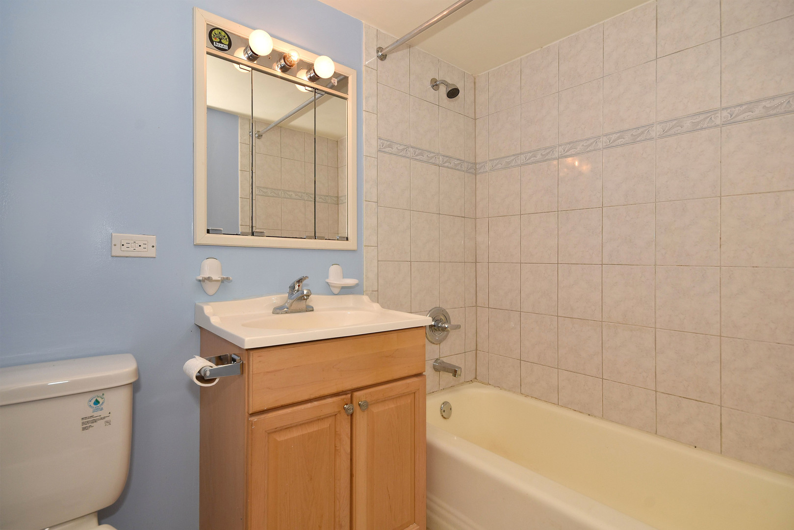 6152 West Rosedale Avenue, Unit 1 Chicago, IL 60646 - Photo 18 of 18 a bathroom with a sink mirror toilet and bathtub