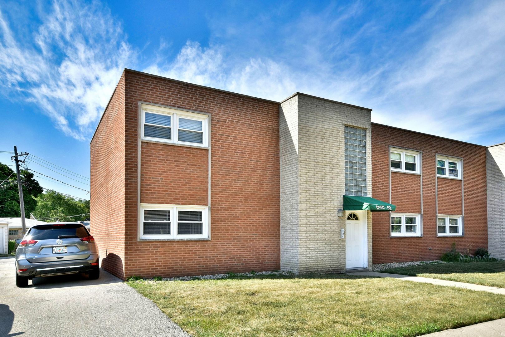 6152 West Rosedale Avenue, Unit 1 Chicago, IL 60646 - Photo 2 of 18 a front view of a house with a yard
