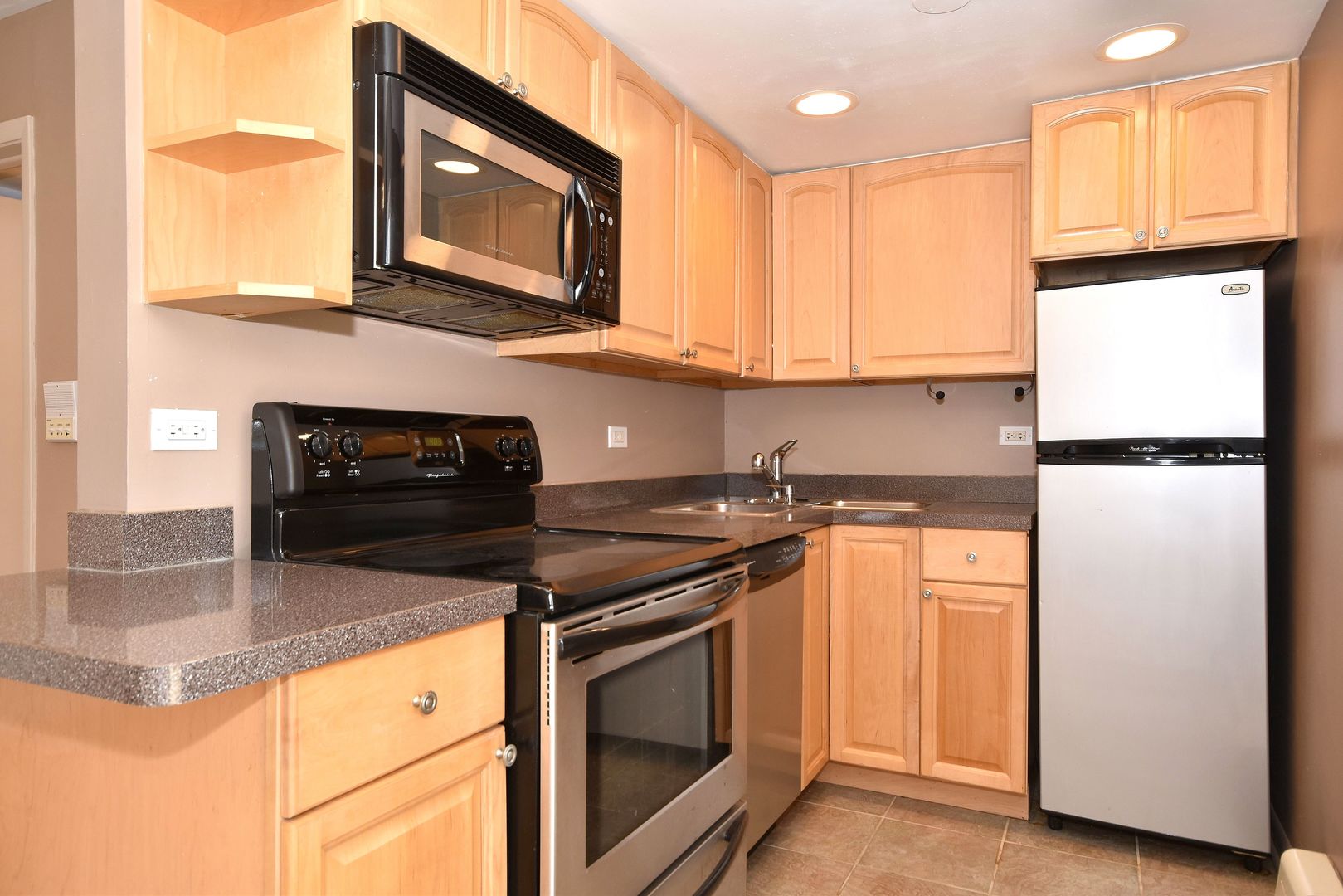 6152 West Rosedale Avenue, Unit 1 Chicago, IL 60646 - Photo 10 of 18 a kitchen with a refrigerator and a stove top oven
