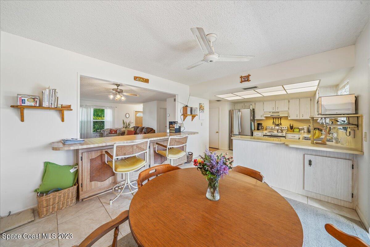 435 Dove Lane, Unit 810 Satellite Beach, FL 32937 - Photo 11 of 43 a room with stainless steel appliances kitchen island granite countertop a sink and cabinets