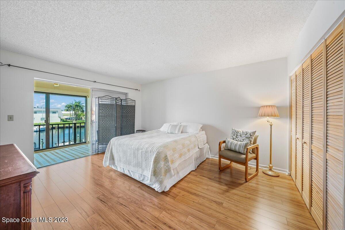 435 Dove Lane, Unit 810 Satellite Beach, FL 32937 - Photo 12 of 43 a spacious bedroom with a bed and a window