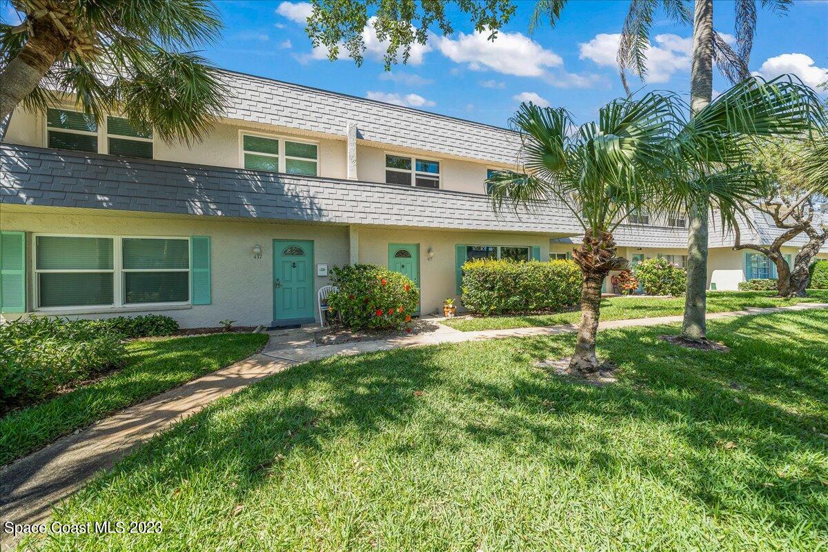 435 Dove Lane, Unit 810 Satellite Beach, FL 32937 - Photo 2 of 43 a view of a house with a yard