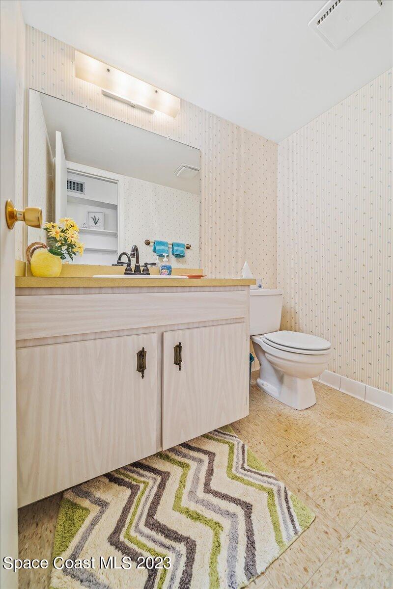 435 Dove Lane, Unit 810 Satellite Beach, FL 32937 - Photo 21 of 43 a bathroom with a sink toilet and mirror