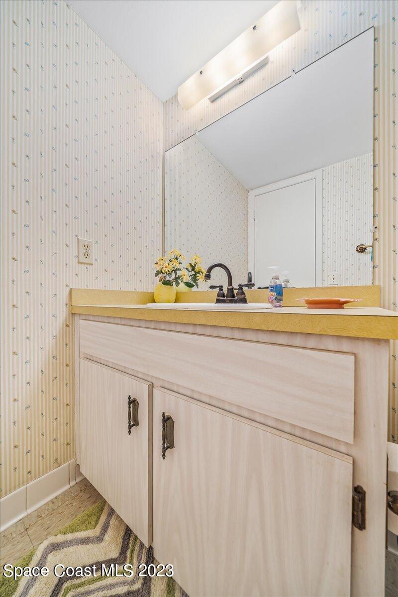 435 Dove Lane, Unit 810 Satellite Beach, FL 32937 - Photo 22 of 43 a bathroom with a sink and a mirror