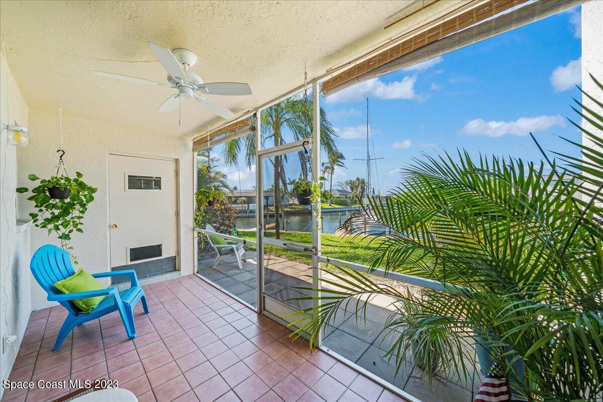 435 Dove Lane, Unit 810 Satellite Beach, FL 32937 - Photo 23 of 43 a view of a chairs and table in a patio