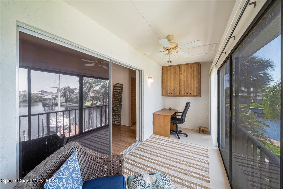 435 Dove Lane, Unit 810 Satellite Beach, FL 32937 - Photo 26 of 43 a workspace with wooden floor and a balcony
