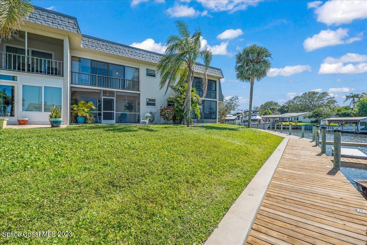 435 Dove Lane, Unit 810 Satellite Beach, FL 32937 - Photo 28 of 43 a swimming pool with outdoor seating and yard