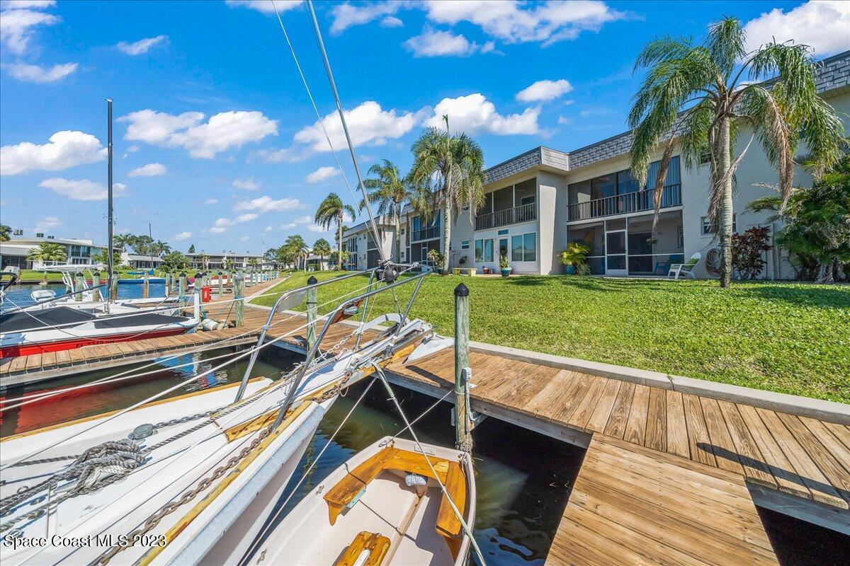 435 Dove Lane, Unit 810 Satellite Beach, FL 32937 - Photo 30 of 43 a view of a swimming pool with a lounge chairs