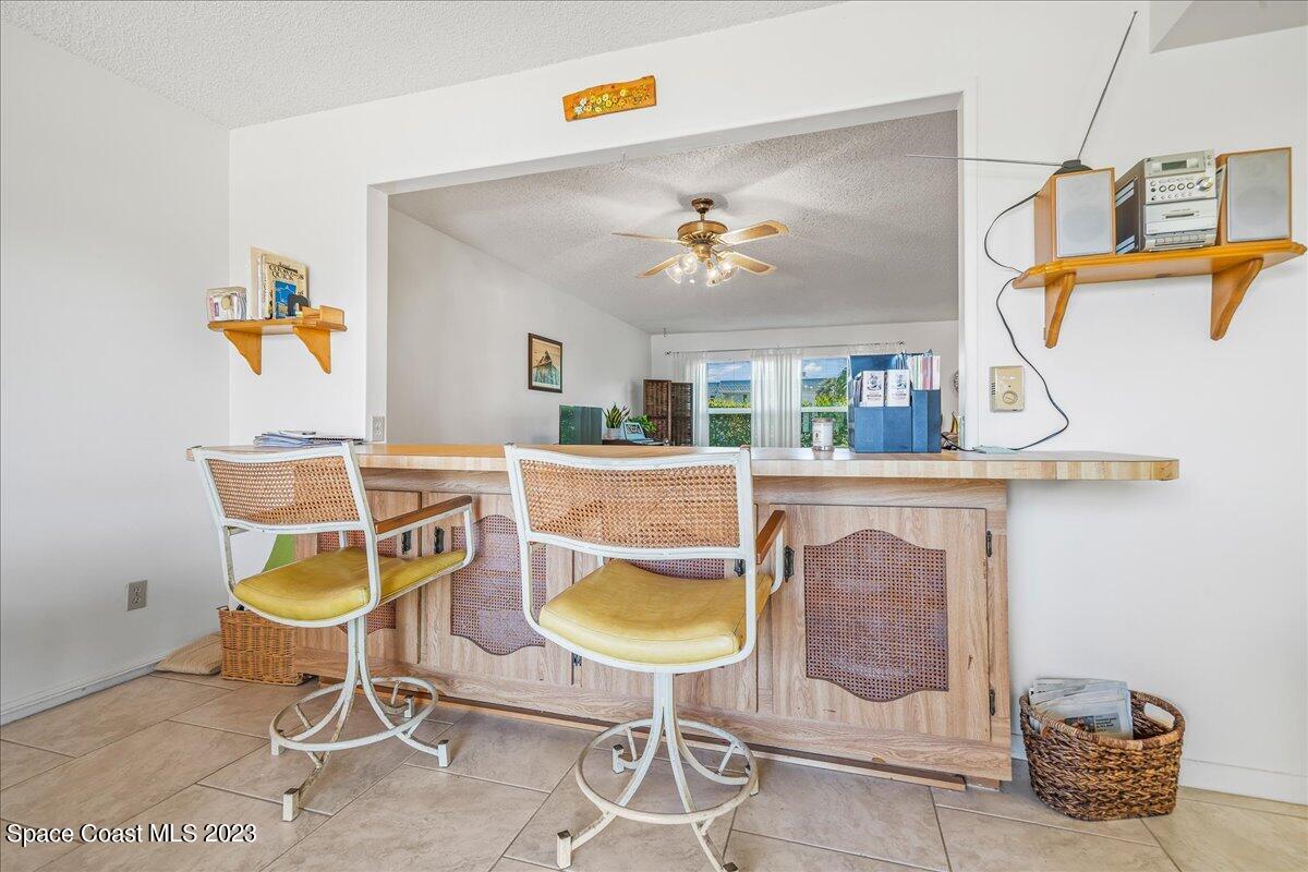 435 Dove Lane, Unit 810 Satellite Beach, FL 32937 - Photo 10 of 43 a living room with furniture and a table