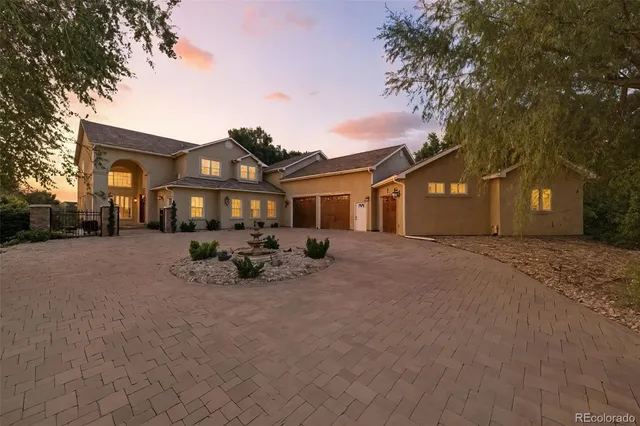 a view of a house with a yard covered in snow