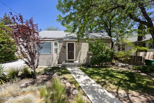 a view of a house with a tree in the background