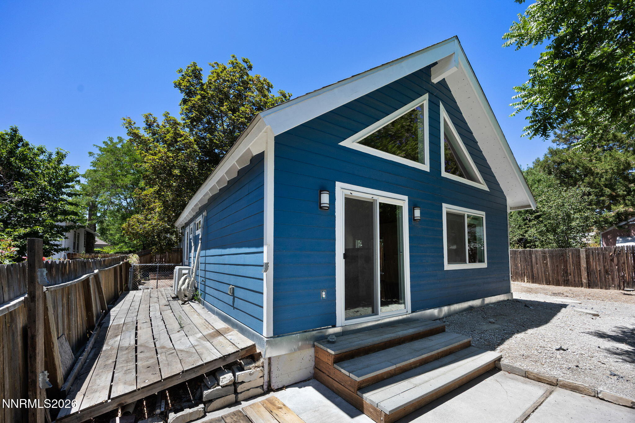 1350 Ridgeway Court Reno, NV 89503 - Photo 26 of 34 a view of backyard with wooden deck and a large tree