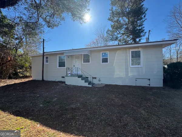 a view of a house with a yard and garage