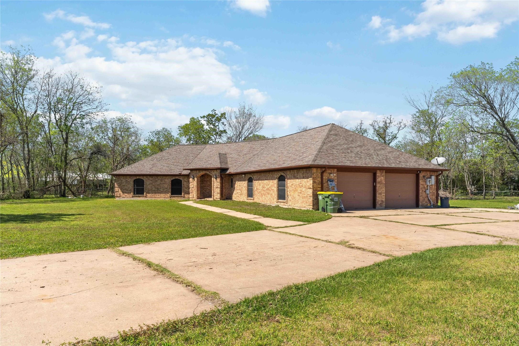 7825 Hughes Ranch Road Pearland, TX 77581 - Photo 3 of 28 The impressive brick front elevation and expansive open grounds create a peaceful, inviting country-style setting that feels like a world apart — even though everything you need is right around the corner.