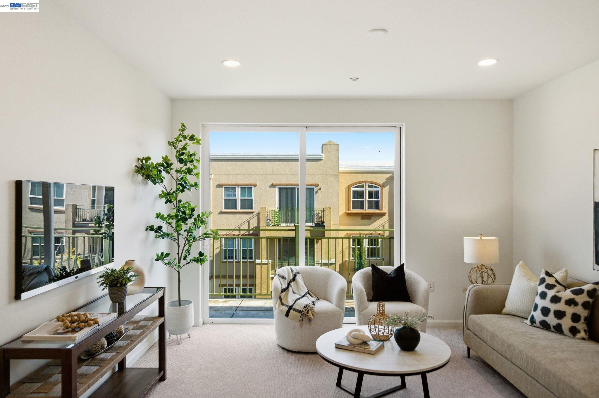 a living room with furniture and a potted plant