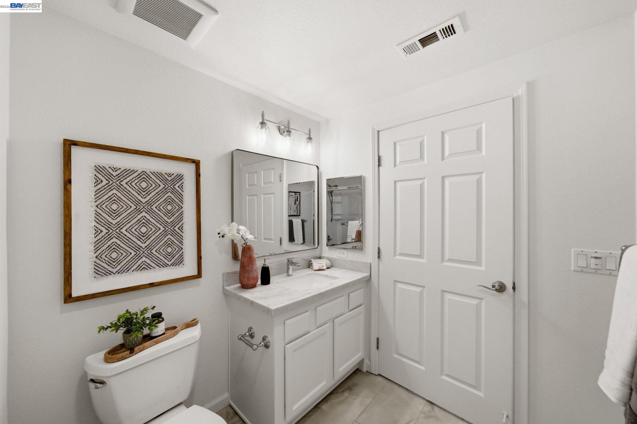 49002 Cinnamon Fern Common, Unit 507 Fremont, CA 94539 - Photo 18 of 41 a bathroom with a double vanity sink and a mirror