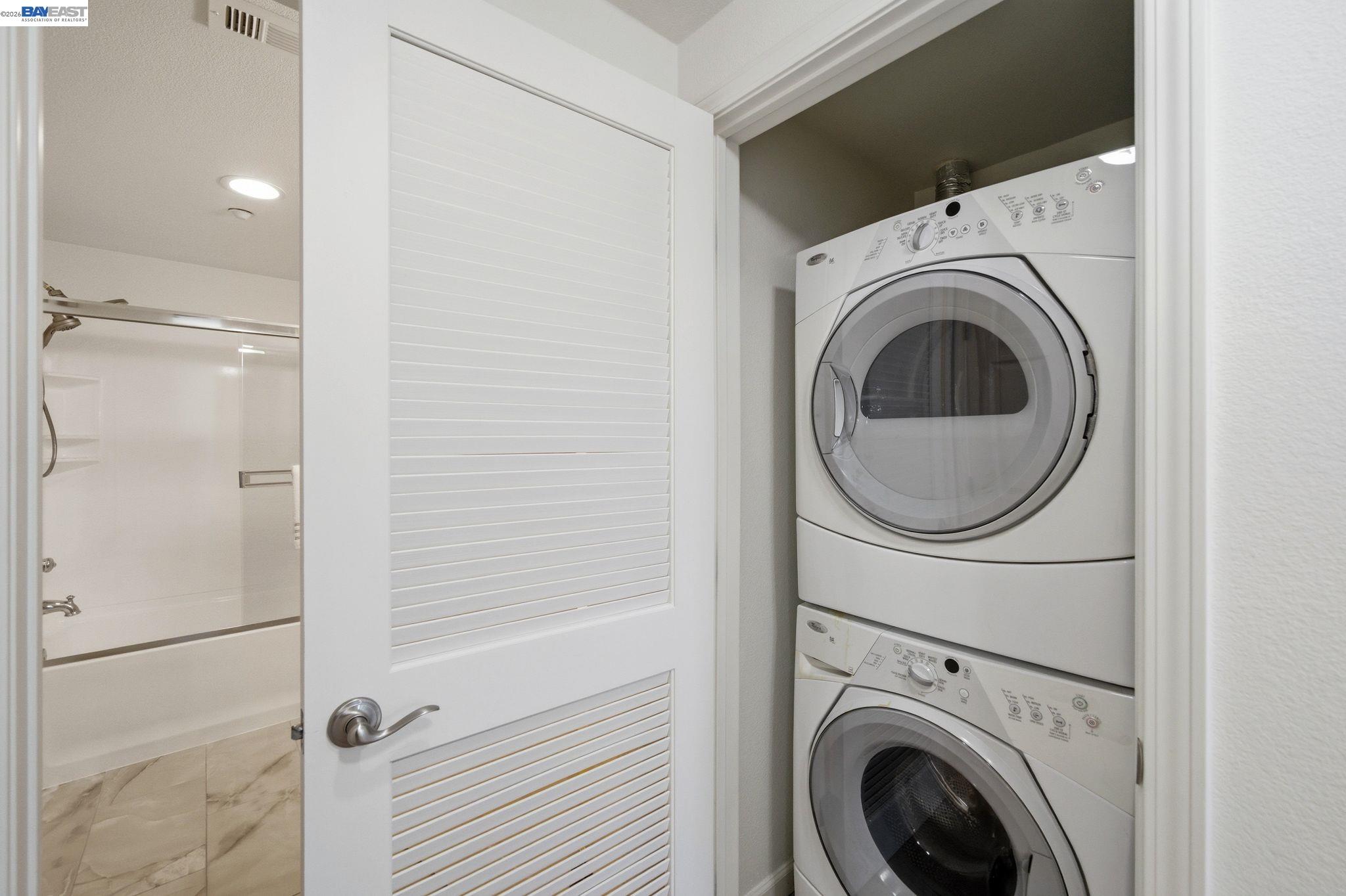 49002 Cinnamon Fern Common, Unit 507 Fremont, CA 94539 - Photo 20 of 41 a view of a hallway with washer and dryer