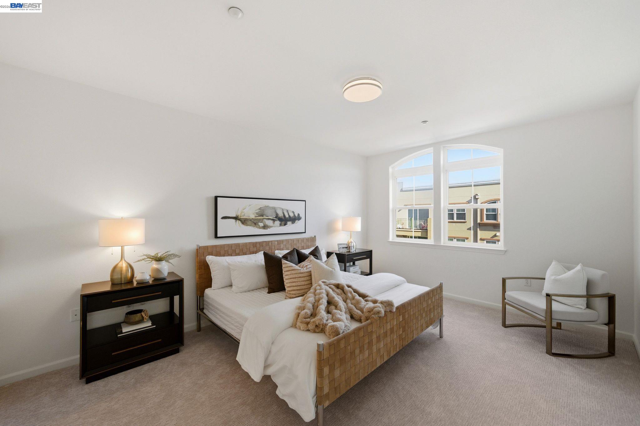 49002 Cinnamon Fern Common, Unit 507 Fremont, CA 94539 - Photo 21 of 41 a spacious bedroom with a bed and a couch