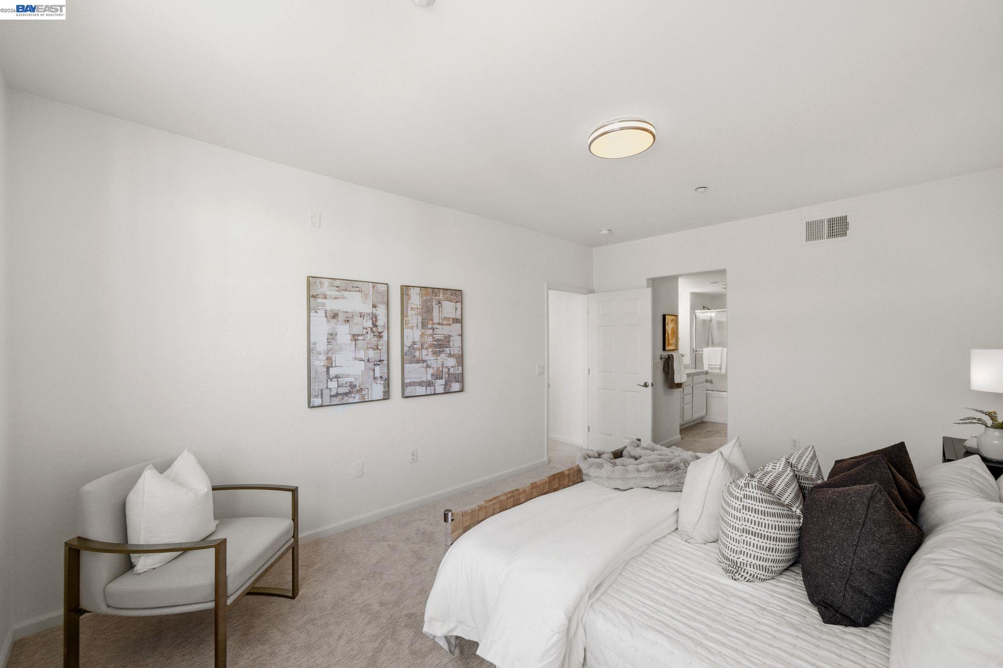 49002 Cinnamon Fern Common, Unit 507 Fremont, CA 94539 - Photo 22 of 41 a bedroom with a bed and a chair