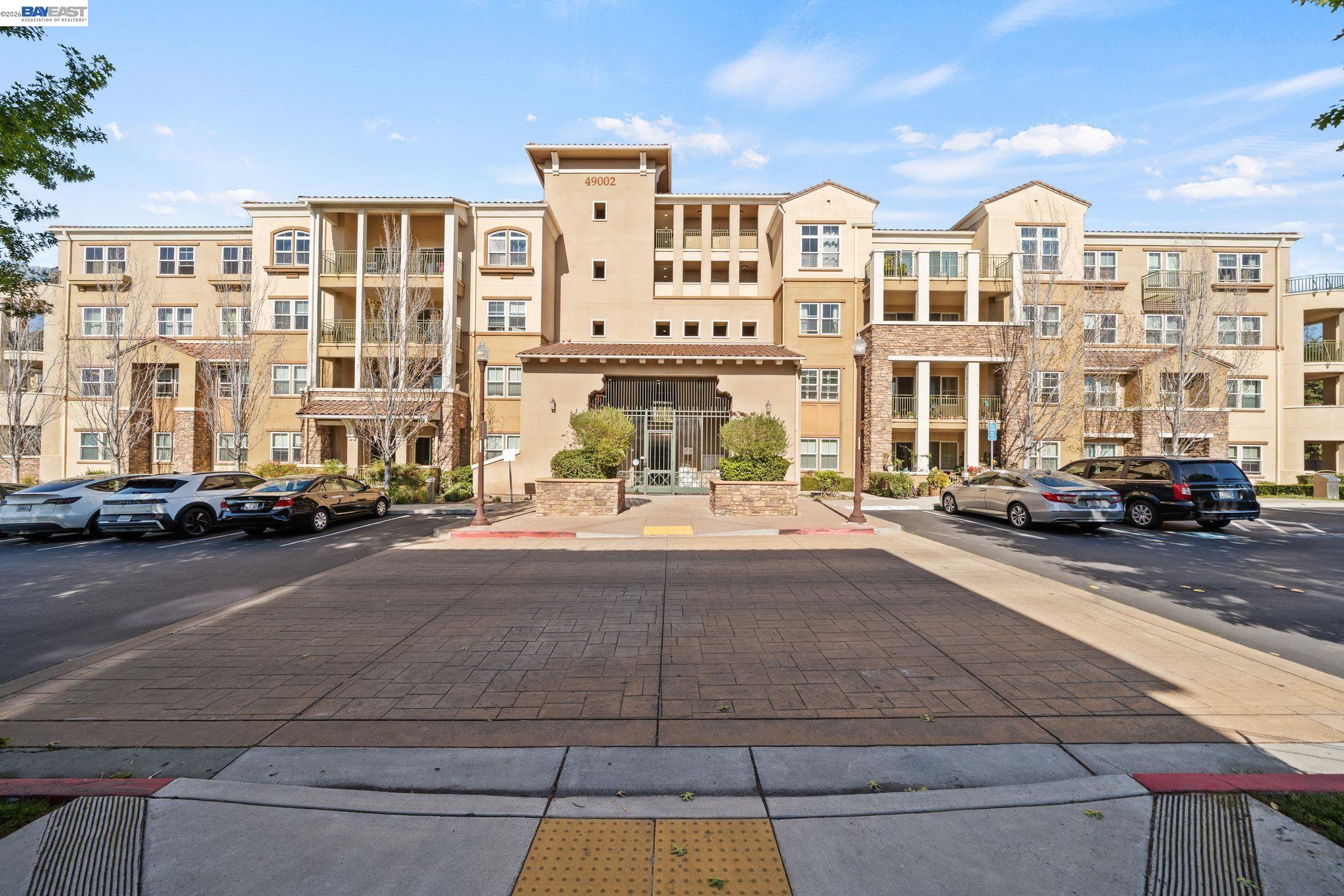49002 Cinnamon Fern Common, Unit 507 Fremont, CA 94539 - Photo 27 of 41 a city street lined with buildings and cars