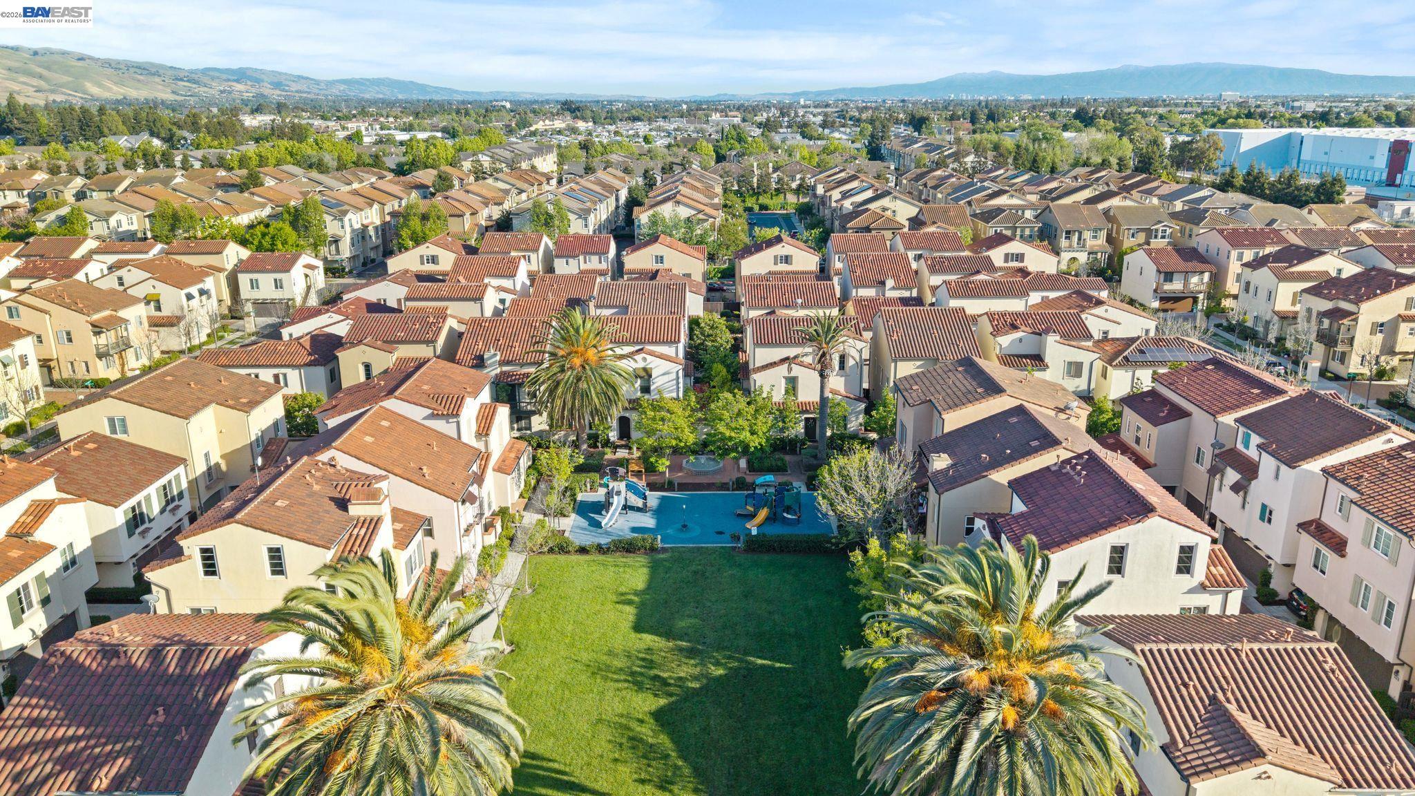 49002 Cinnamon Fern Common, Unit 507 Fremont, CA 94539 - Photo 40 of 41 an aerial view of residential building with swimming pool and ocean view