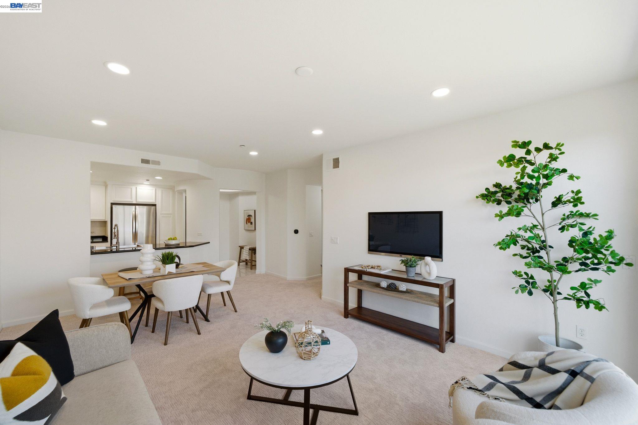 49002 Cinnamon Fern Common, Unit 507 Fremont, CA 94539 - Photo 5 of 41 a living room with furniture and a potted plant