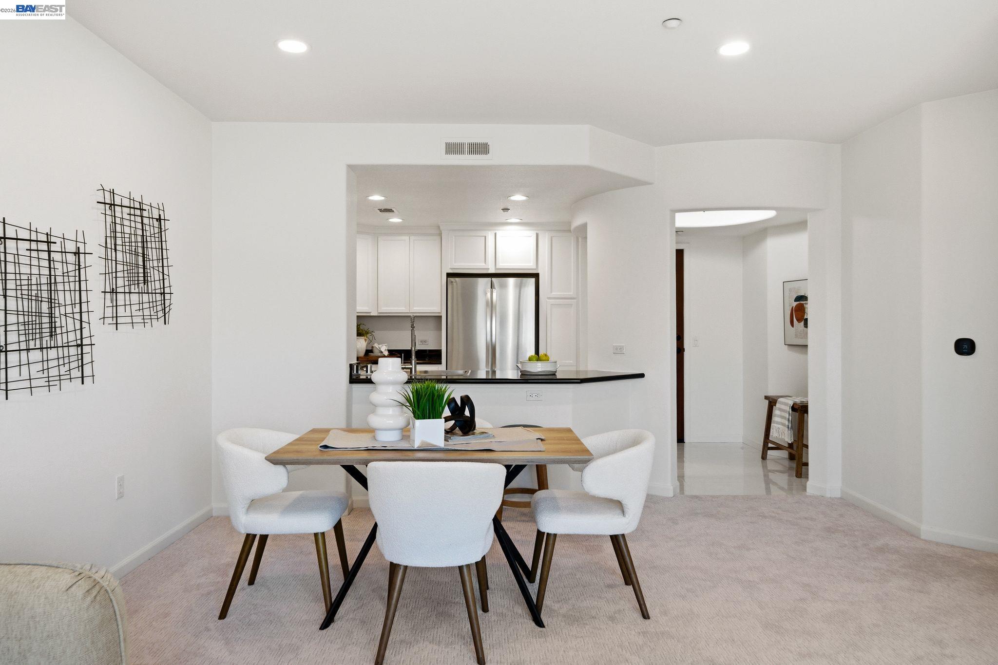 49002 Cinnamon Fern Common, Unit 507 Fremont, CA 94539 - Photo 7 of 41 a view of a dining room with furniture and wooden floor