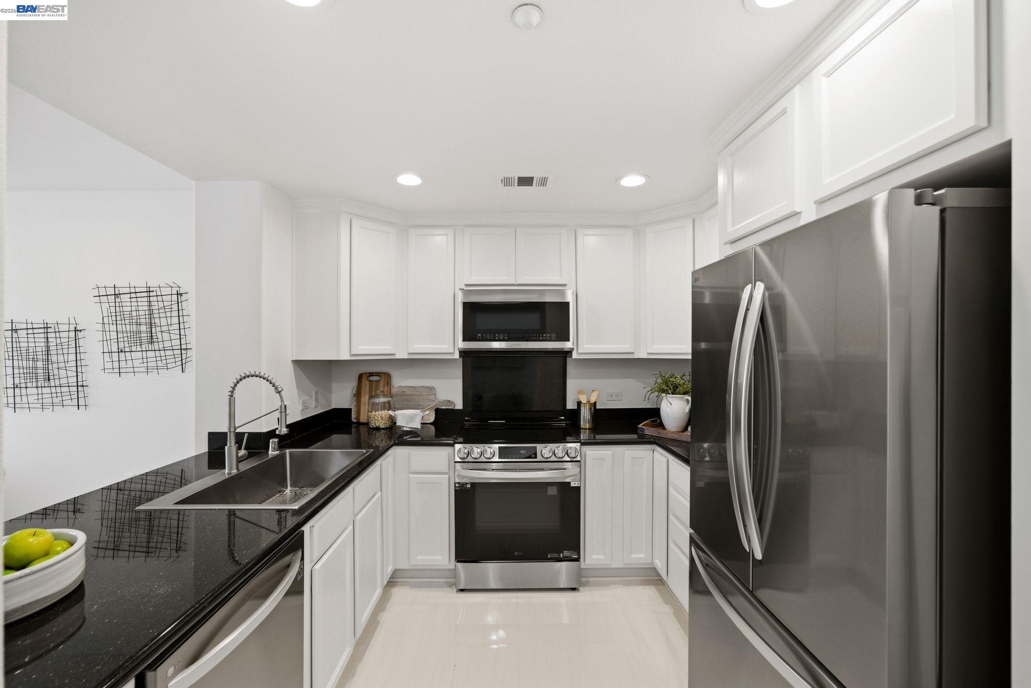 49002 Cinnamon Fern Common, Unit 507 Fremont, CA 94539 - Photo 10 of 41 a kitchen with a refrigerator sink and stove