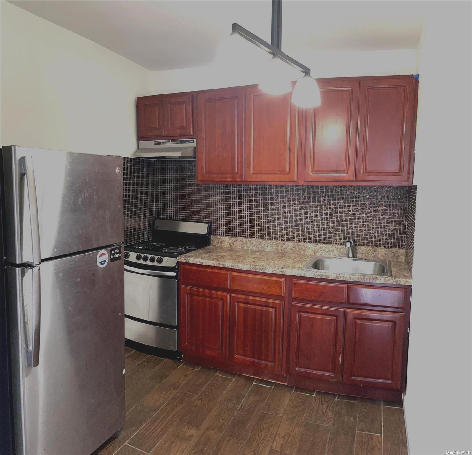 195 Stanhope Street, Unit 4F Brooklyn, NY 11237 - Photo 1 of 1 a kitchen with stainless steel appliances granite countertop a stove a refrigerator and a sink