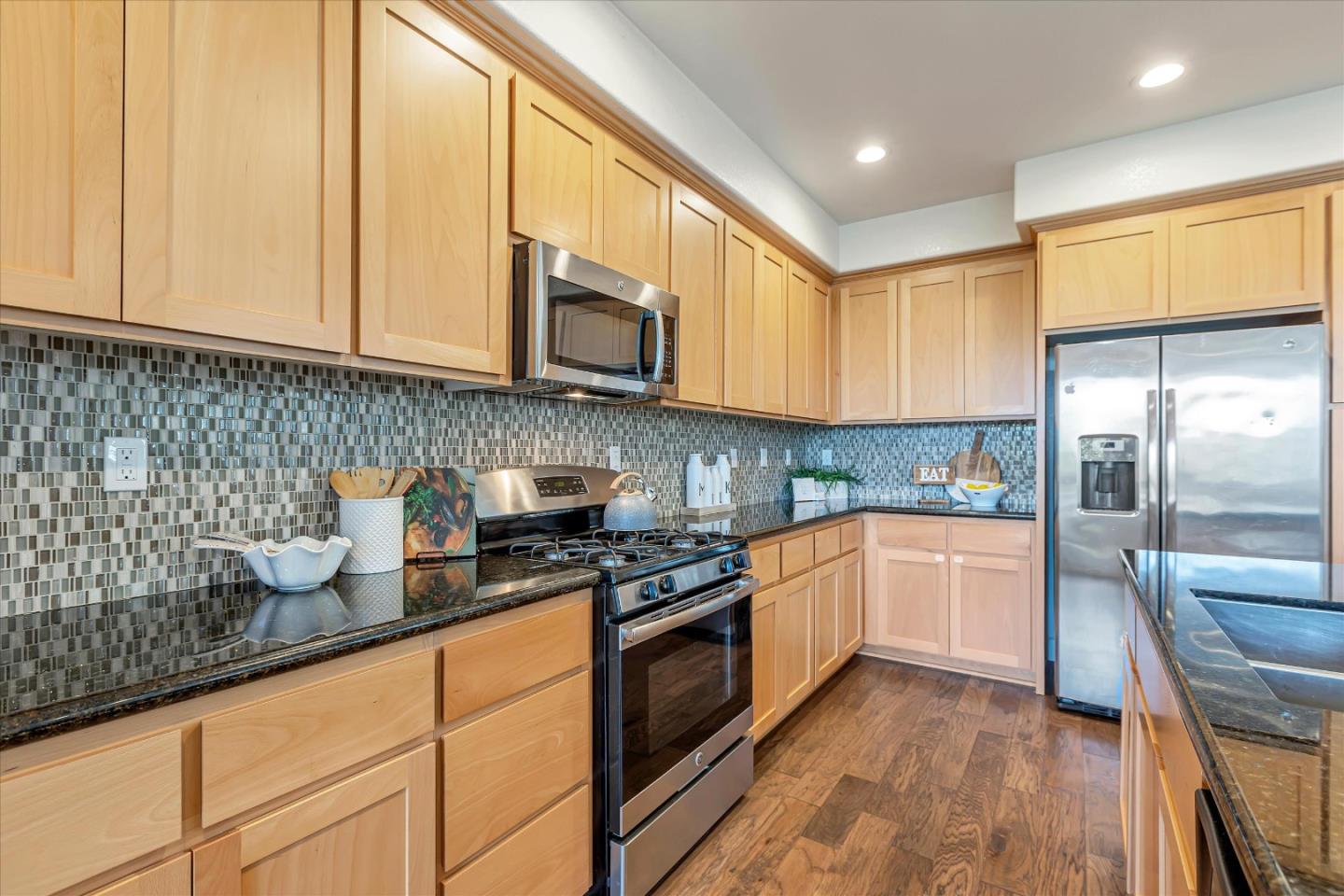 103 Incense Terrace Sunnyvale, CA 94086 - Photo 11 of 42 a kitchen with stainless steel appliances granite countertop a stove a sink and a microwave