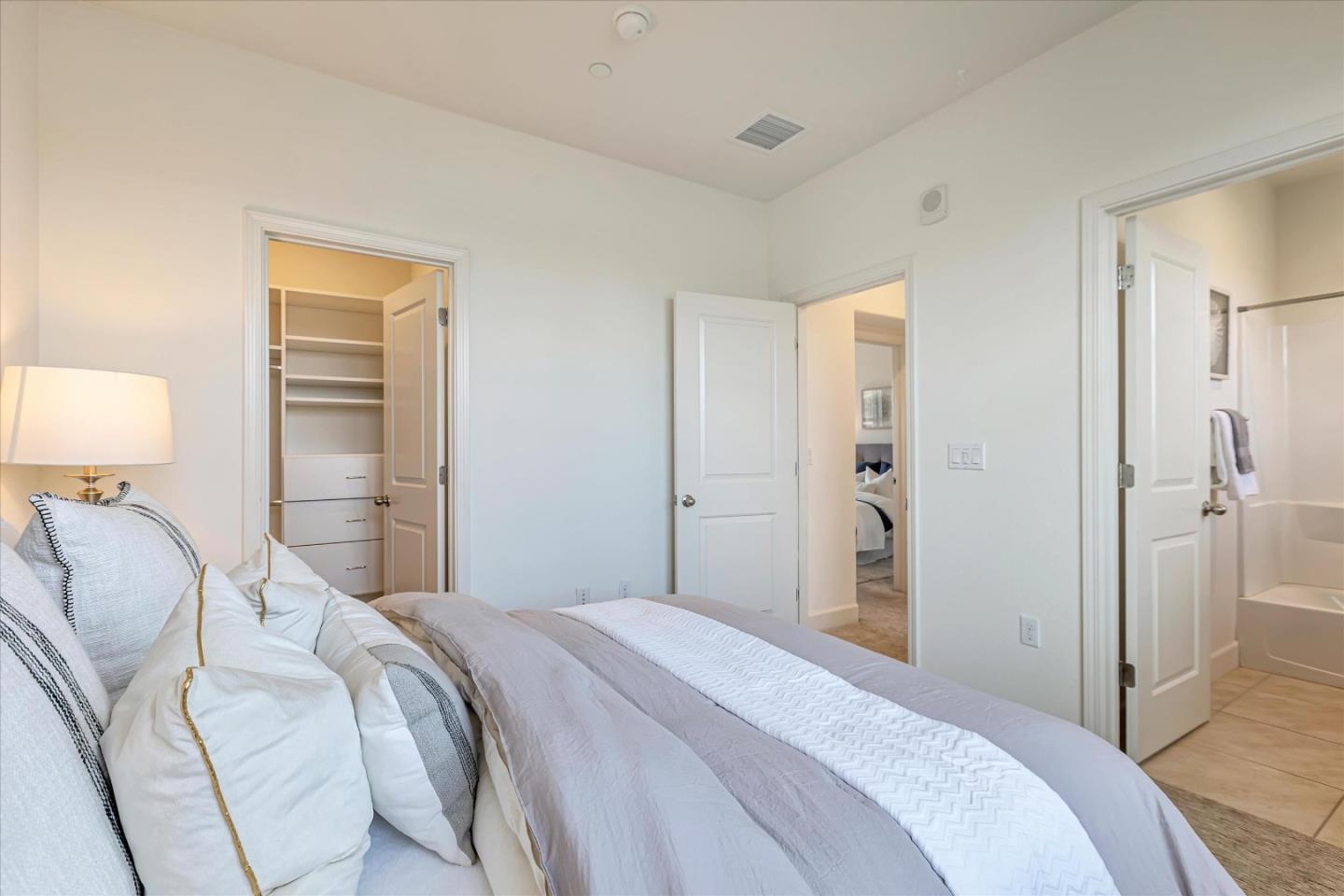 103 Incense Terrace Sunnyvale, CA 94086 - Photo 21 of 42 a bedroom with a bed and a lamp