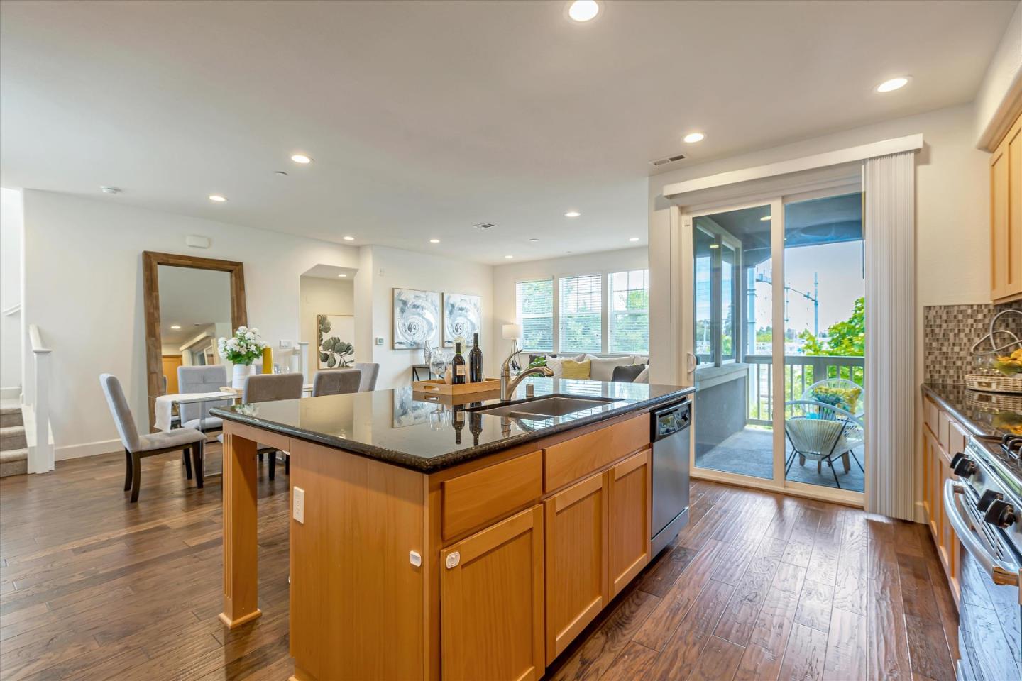 103 Incense Terrace Sunnyvale, CA 94086 - Photo 9 of 42 a kitchen with stainless steel appliances granite countertop counter space and wooden floor