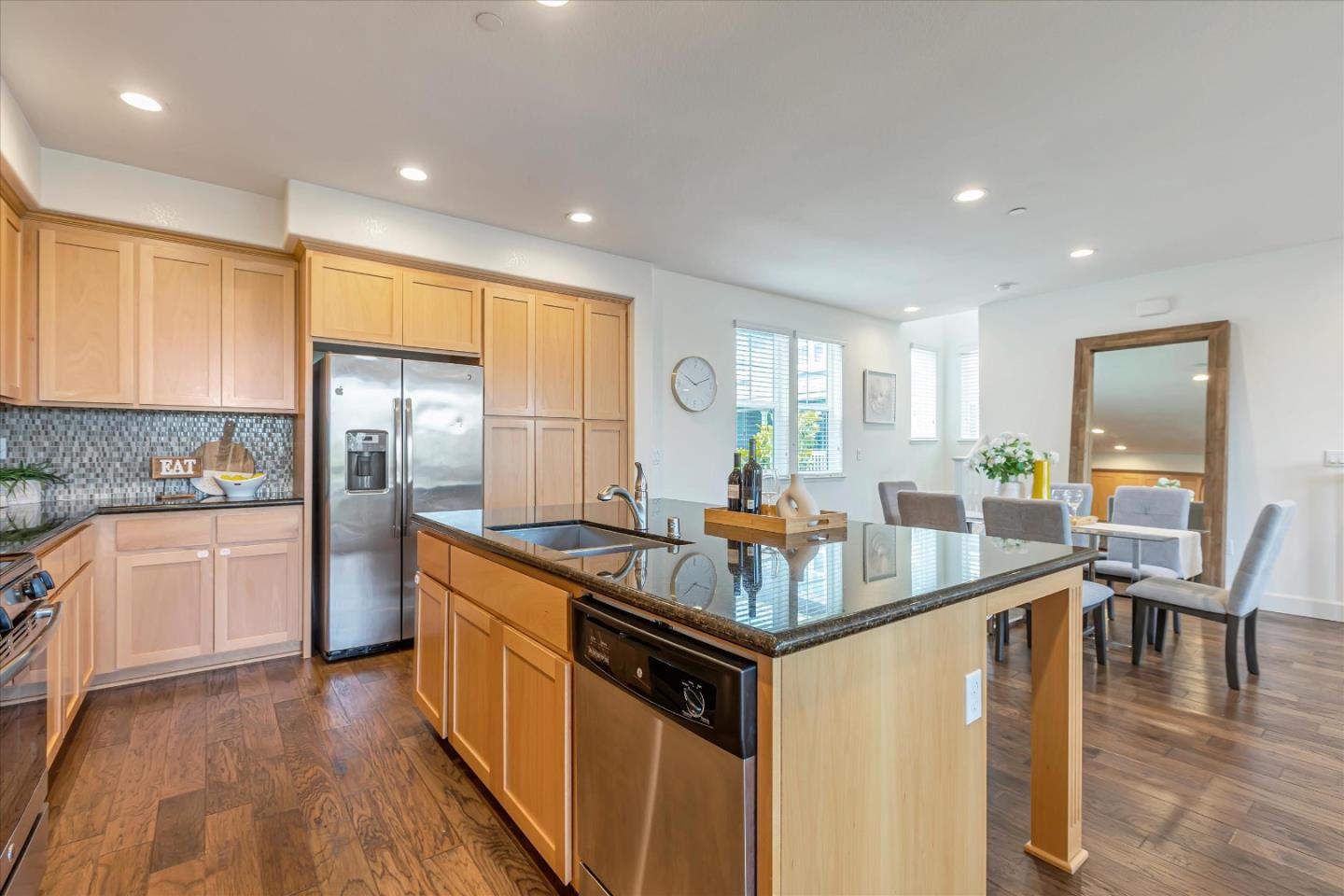 103 Incense Terrace Sunnyvale, CA 94086 - Photo 10 of 42 a kitchen with stainless steel appliances granite countertop a stove a sink a refrigerator and white cabinets with wooden floor
