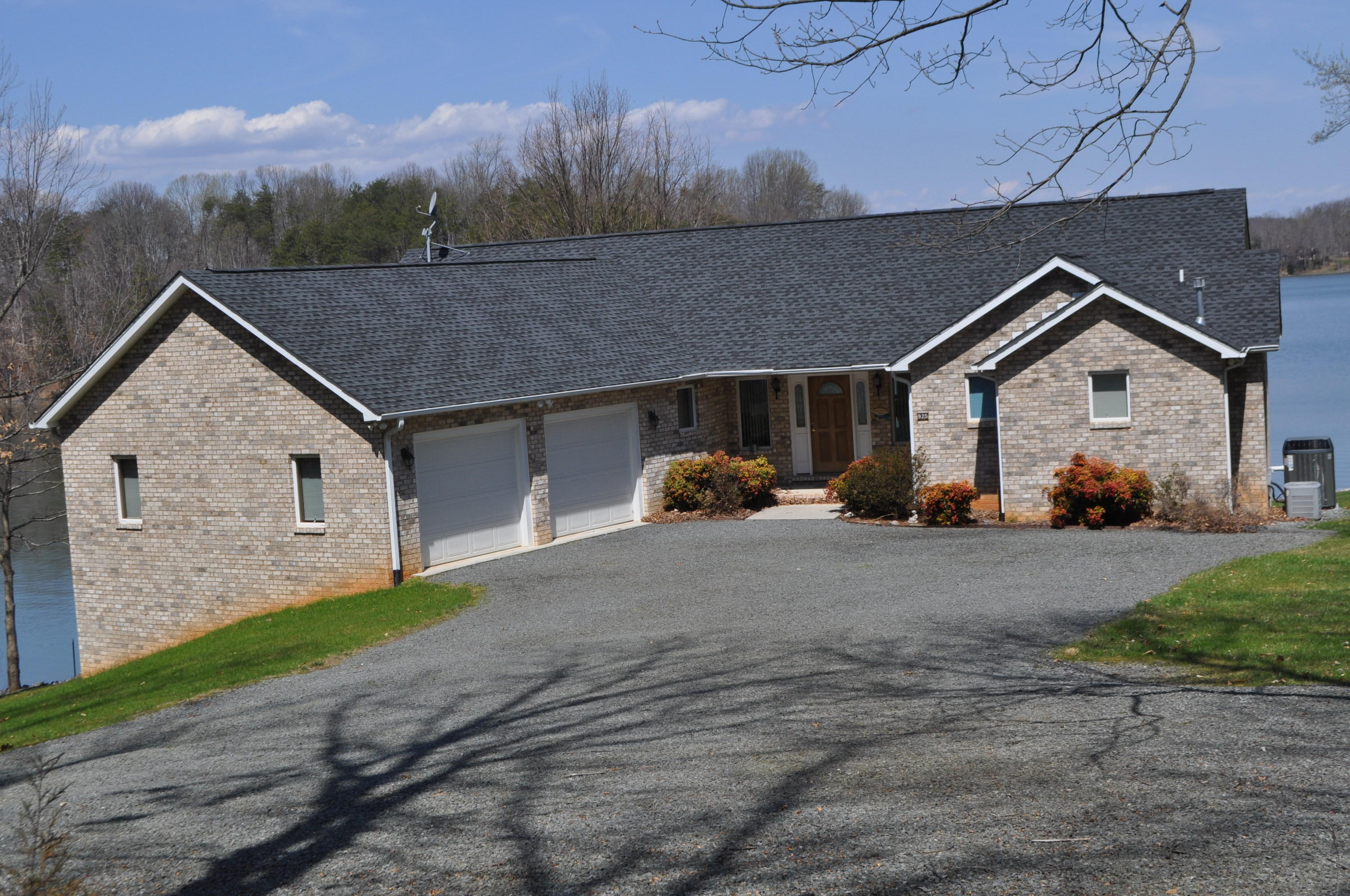 925 Somerset Cove Road Union Hall, VA 24176 - Photo 3 of 35 a front view of a house with a yard and garage