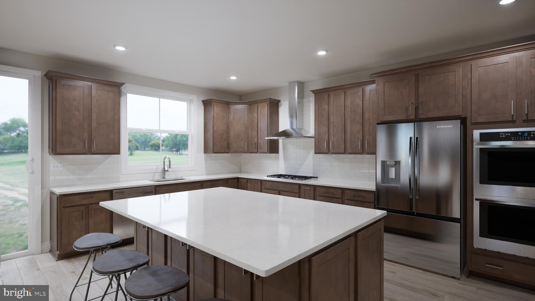 Snowden Bridge Boulevard, Unit SHELDON Stephenson, VA 22656 - Photo 29 of 53 a kitchen with kitchen island a counter space and a refrigerator