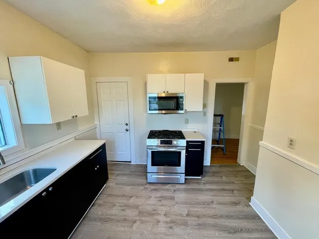 a kitchen with a stove and a refrigerator