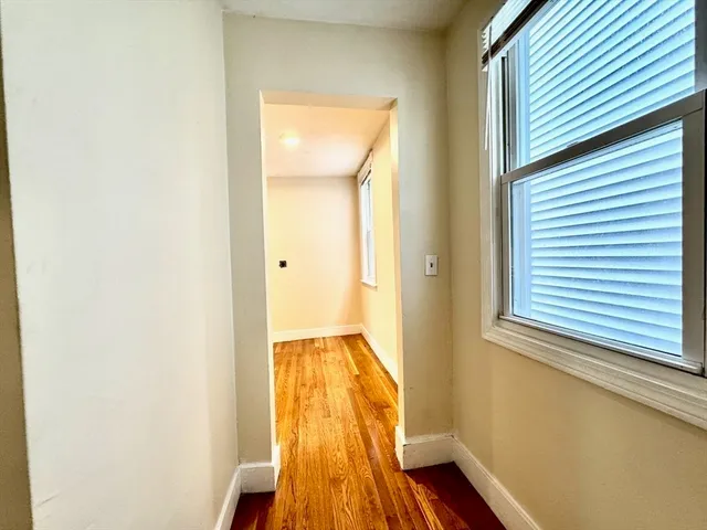 a view of hallway with wooden floor