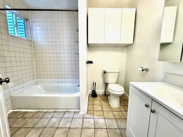 a bathroom with a bathtub and a toilet