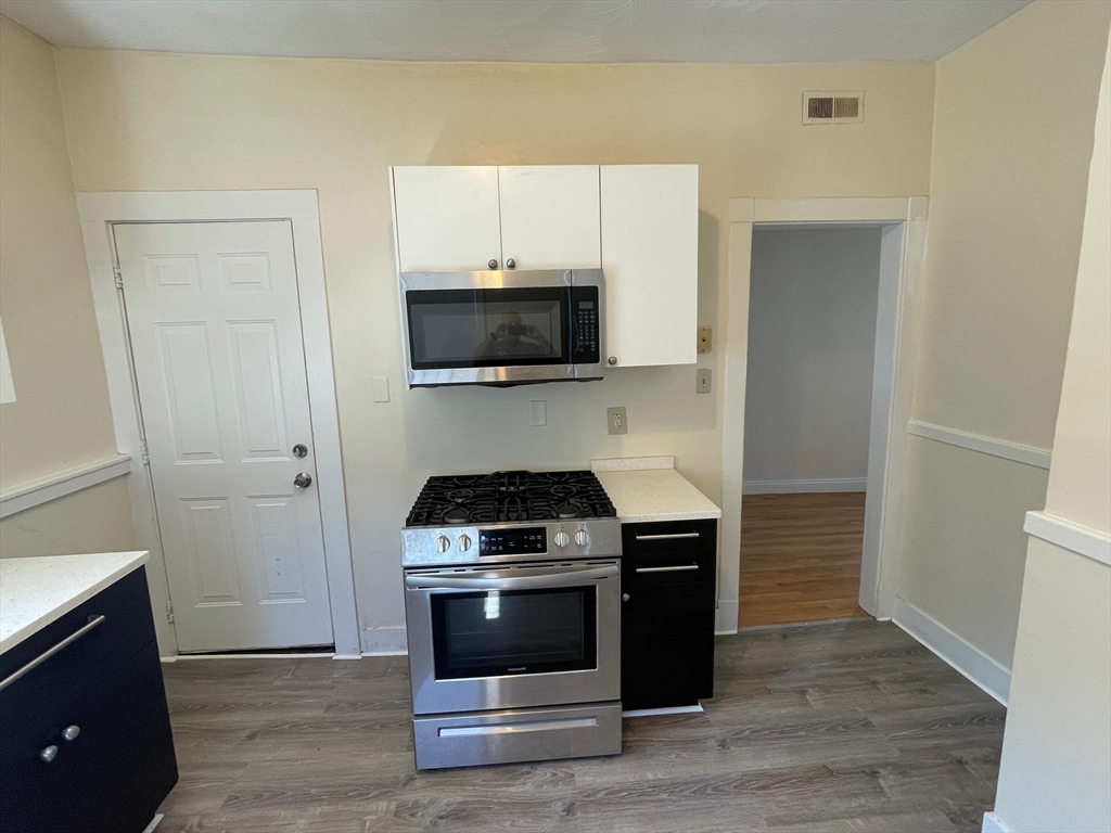 6 Calder Street, Unit 3 Boston, MA 02124 - Photo 16 of 23 a kitchen with a stove and a microwave