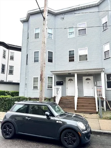 a front view of a house with parking space