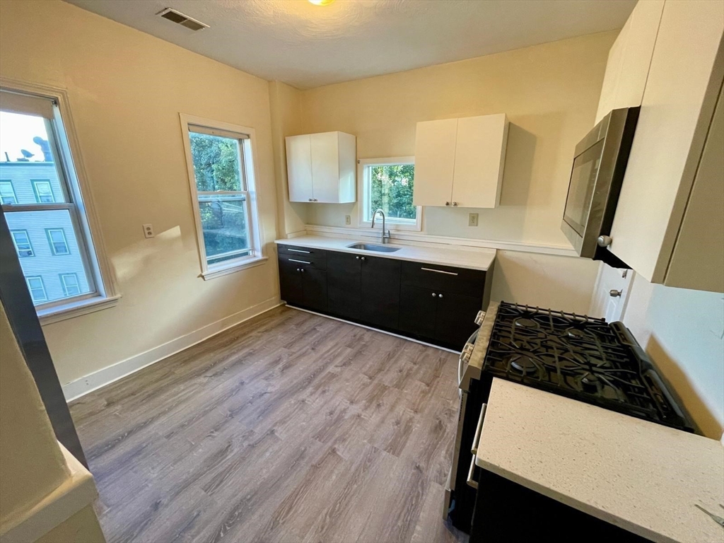 6 Calder Street, Unit 3 Boston, MA 02124 - Photo 4 of 23 a room with wooden floor and window