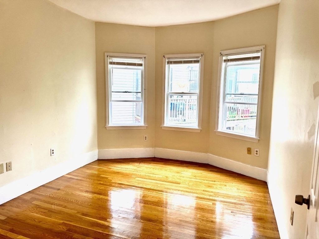 6 Calder Street, Unit 3 Boston, MA 02124 - Photo 7 of 23 a view of empty room with window and wooden floor