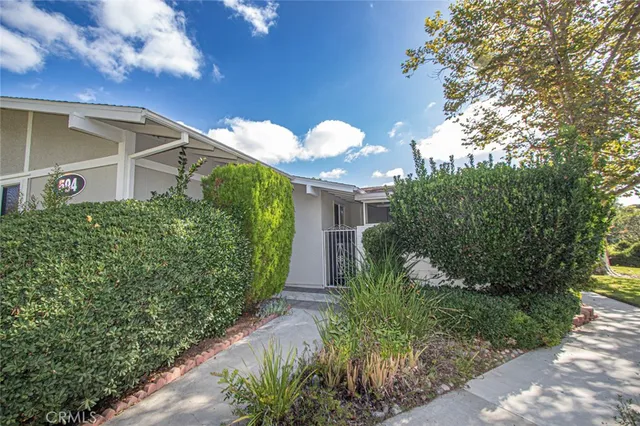 a view of a house with a yard and garden