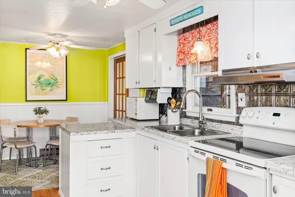 a kitchen with a sink cabinets and window