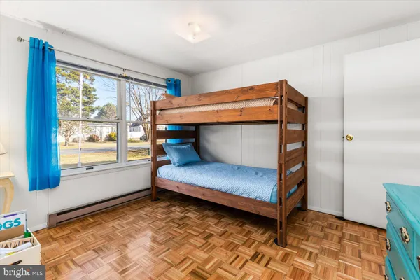 a bedroom with furniture and a window