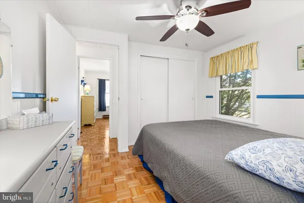a spacious bedroom with a bed and a chandelier