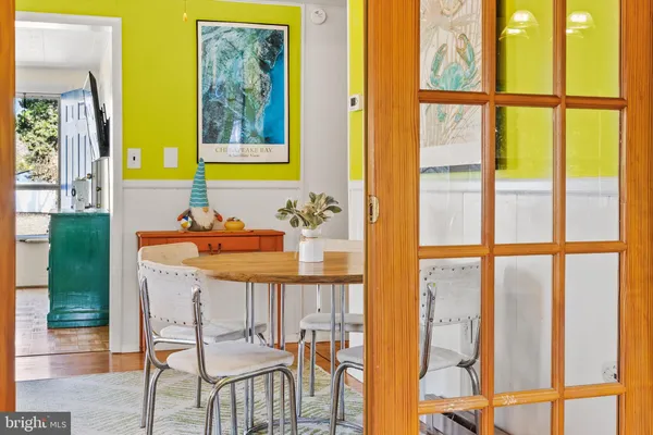 a dining room with furniture and a window