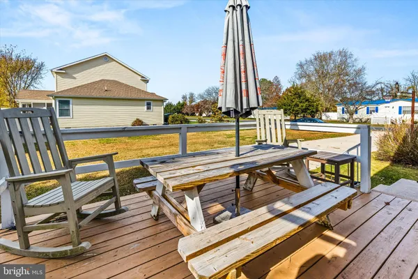 a view of a balcony with chairs and wooden floor
