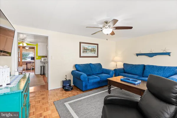 a living room with furniture a couch and a chandelier